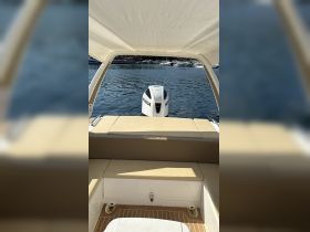 Interior view of a boat showcasing the seating area and engine, ideal for relaxing while enjoying the water.