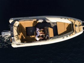 An aerial view of a couple enjoying their time aboard a boat, showcasing the perfect blend of relaxation and adventure on the water.