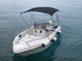 A sleek speedboat anchored in calm waters, featuring a rental sign for boating enthusiasts looking to explore the sea.