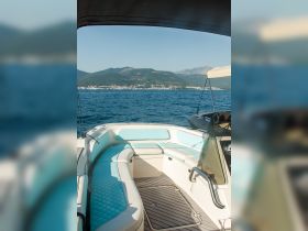 Interior view of a stylish boat cabin featuring comfortable seating and a sleek design, perfect for relaxing on the water.