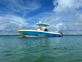 A vibrant speedboat anchored in calm waters, showcasing its striking design and inviting atmosphere — perfect for a day of adventure on the water.