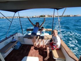 A joyful moment aboard a boat with kids enjoying the ride, showcasing the fun of family outings on the water.