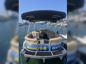 Interior view of a pontoon boat featuring comfortable seating, ideal for relaxing on water tours. Perfect for group outings and family adventures.