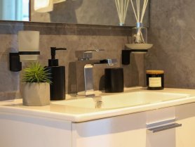A stylish bathroom interior featuring a modern sink, decorative elements, and elegant fixtures, perfect for enhancing the onboard experience.