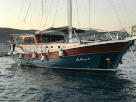 A beautifully crafted yacht named 'Su Perist C' docked in calm waters, showcasing its elegant design and serene surroundings.