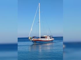 A beautiful sailboat glides through calm waters under a clear blue sky, showcasing its elegant design and perfect for serene sailing adventures.