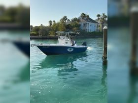 A speedboat navigates through clear turquoise waters, showcasing its sleek design and vibrant colors, perfect for a day of adventure on the water.