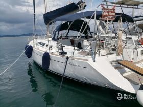 A stunning view of the Sund Odyssey 49 yacht docked in calm waters, showcasing its sleek design and inviting atmosphere for sailing adventures.