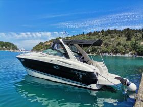 A sleek Monterey boat docked in tranquil waters, surrounded by lush greenery — perfect for a day of relaxation on the water.