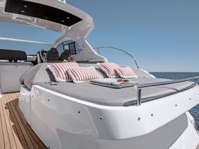 A stylish lounge area on a yacht featuring comfortable cushions and a sleek design, perfect for relaxing while enjoying the open water.