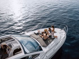 A family enjoys a relaxing day on the deck of a boat, soaking up the sun and creating lasting memories on the water.