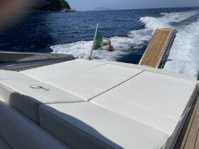 A luxurious lounge area on a boat, featuring plush white cushions, perfect for relaxing while cruising through beautiful waters.