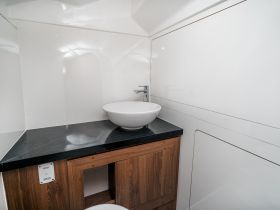 A sleek and modern bathroom interior on a boat featuring a stylish sink and ample storage, perfect for onboard comfort.
