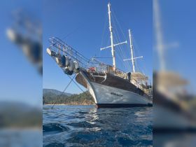 A stunning view of the 'Şener Kaptan' yacht, showcasing its elegant design against a clear blue sky, perfect for luxury sailing experiences.