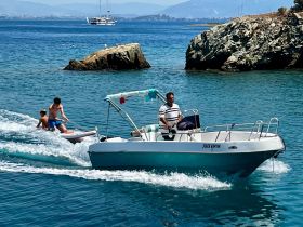 A thrilling moment on the water as a family enjoys jet skiing while a boat navigates nearby, showcasing the fun of summer adventures on the sea.