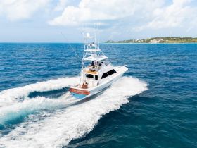 A stunning aerial view of a yacht named 'Real Paradise' cruising through vibrant blue waters, showcasing the beauty of boating adventures.