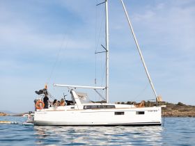 A group enjoys a relaxing day aboard a sailing yacht, surrounded by serene ocean waters — perfect for a day of leisure and adventure.