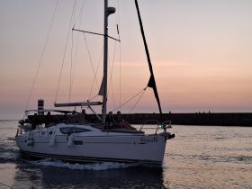 A beautiful sunset sail aboard the Azimuth, with guests enjoying the serene waters and stunning views — perfect for memorable evening cruises.
