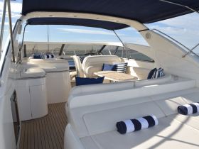 A beautifully designed interior of a yacht featuring comfortable seating and a stylish lounge area, perfect for relaxing while cruising on the water.