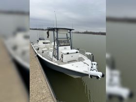 A well-equipped center console boat docked at the marina, showcasing its spacious layout and fishing gear — perfect for a day on the water.