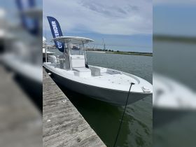 A sleek center console boat docked at the marina, showcasing its modern design and ready for a day on the water.