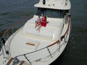 A couple enjoys a relaxing moment on the deck of a yacht, perfect for romantic getaways or special celebrations on the water.