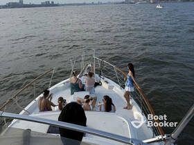 A group of friends enjoys a relaxing day on the boat, capturing moments and celebrating together on the water.