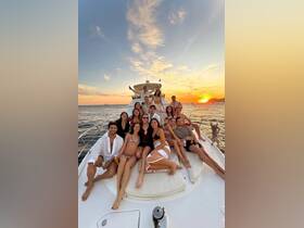 A lively group enjoys a sunset celebration aboard a yacht, capturing the essence of fun and friendship on the water.