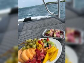 A vibrant fruit platter featuring a variety of fresh fruits, perfect for enjoying on a boat trip. Ideal for catering or snack options while cruising.