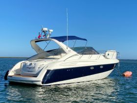 A stunning side view of the 'Angel A' yacht docked in calm waters, showcasing its elegant design and perfect for luxury outings.