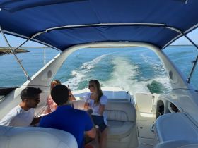 A lively group enjoys drinks aboard a boat, creating a perfect atmosphere for celebrations on the water.