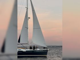 A group enjoys a serene sailing experience at sunset aboard a yacht named 'Sailing with Sal' — perfect for memorable outings on the water.