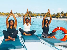 A group of women practicing yoga on a boat, enjoying a serene moment on the water — perfect for wellness retreats and relaxation experiences.