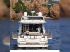 A couple enjoys a relaxing moment aboard a luxurious yacht, surrounded by stunning coastal scenery — perfect for a serene getaway on the water.