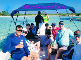 A cheerful group enjoys a boat tour in Belize, capturing the essence of adventure and relaxation on the water.