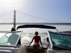 A scenic moment on a boat with friends, showcasing the iconic bridge in the background — perfect for enjoying the views while cruising.