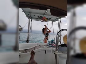 A woman enjoys an onboard activity on a boat, showcasing the fun and relaxation of a day at sea.