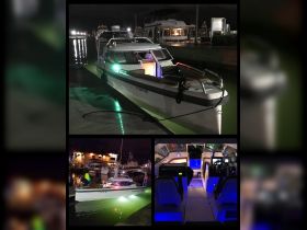 A sleek boat illuminated at night, showcasing its modern helm and cabin design, perfect for evening cruises or fishing trips.