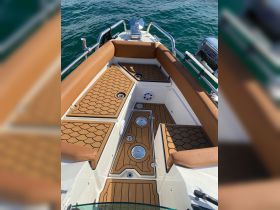 A well-designed interior view of a boat showcasing comfortable seating and a stylish helm area, perfect for enjoying time on the water.