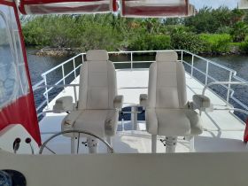 Interior view of a boat's helm featuring two seating areas, ideal for navigating the waters in comfort.