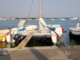 A catamaran docked at the marina, showcasing its sleek design and ready for the next adventure on the water.