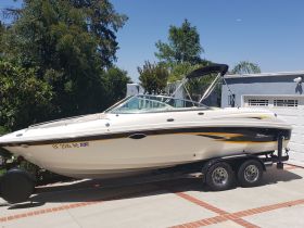 A sleek speedboat parked in a driveway, showcasing its elegant design and ready for adventure on the water.