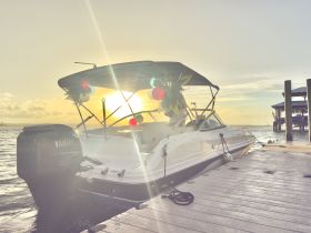 A stunning view of a speedboat docked at sunset, showcasing its sleek design and festive decorations — perfect for evening cruises.