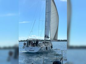 A lively group enjoys sailing aboard the McLir, capturing the essence of adventure on the open water.