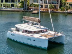 A stunning catamaran docked in calm waters, showcasing its sleek design and spacious layout, perfect for luxurious sailing adventures.