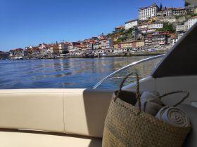 A scenic view from a boat showcasing a vibrant cityscape along the coastline, perfect for exploring picturesque waterfronts.