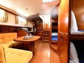 A beautifully designed boat interior featuring a cozy lounge area and well-equipped cabin, perfect for relaxing during your nautical adventures.