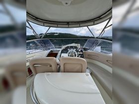 A well-equipped helm area inside a boat, showcasing the steering console and seating, perfect for navigating the waters in comfort.
