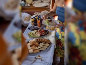 A beautifully arranged spread of snacks and drinks on board, perfect for enjoying while cruising — featuring fresh fruits, cookies, and refreshing beverages.