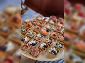 A beautifully arranged platter of gourmet appetizers, perfect for onboard catering during a luxurious boat trip.